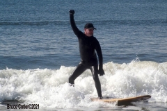 NEW YORK -  Black Surfers Association have a paddle out to honor George Floyd and Daunte Wright in Far Rockaway Queens at Beach 91st. Street. Surfers take to the water hold a prayer circle and place flowers in the water while family members and friends hold signs on the beach.