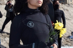 NEW YORK -  Black Surfers Association have a paddle out to honor George Floyd and Daunte Wright in Far Rockaway Queens at Beach 91st. Street. Surfers take to the water hold a prayer circle and place flowers in the water while family members and friends hold signs on the beach.