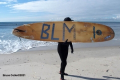 NEW YORK -  Black Surfers Association have a paddle out to honor George Floyd and Daunte Wright in Far Rockaway Queens at Beach 91st. Street. Surfers take to the water hold a prayer circle and place flowers in the water while family members and friends hold signs on the beach.