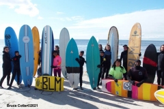 NEW YORK -  Black Surfers Association have a paddle out to honor George Floyd and Daunte Wright in Far Rockaway Queens at Beach 91st. Street. Surfers take to the water hold a prayer circle and place flowers in the water while family members and friends hold signs on the beach.