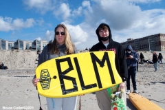 NEW YORK -  Black Surfers Association have a paddle out to honor George Floyd and Daunte Wright in Far Rockaway Queens at Beach 91st. Street. Surfers take to the water hold a prayer circle and place flowers in the water while family members and friends hold signs on the beach.