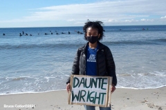 NEW YORK -  Black Surfers Association have a paddle out to honor George Floyd and Daunte Wright in Far Rockaway Queens at Beach 91st. Street. Surfers take to the water hold a prayer circle and place flowers in the water while family members and friends hold signs on the beach.