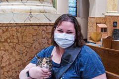 A cat and their human await the ceremony inside the Church of St. Francis of Assisi in NYC for the Blessing of Animals that takes place every year on the first Sunday of October. 
In the Roman Catholic Church, St. Francis of Assisi is patron saint of animals, merchants and ecology.
People from all over bring their beloved furry and not so furry companions to receive blessings. This year broke an all time record of attendees who seek better horizons and better health for the upcoming year. (C) Bianca Otero, NYC. October 3, 2021.
