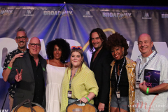 Rock of Broadway panel at BroadwayCon with Ben Cameron (l), Donnie Kehr, Maya Days, Ryann Redmond, Constantine Maroulis, Divaa N’ Kenge, and Joseph Church(r) on the stage at The New Yorker Hotel,NY, July 8, 2022.