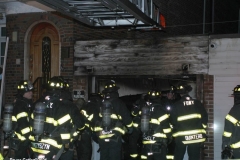 New York City. FDNY personnel extinguish a garage fire on East 29th Street and Kings Highway.