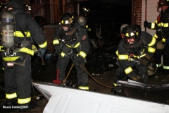 New York City. FDNY personnel extinguish a garage fire on East 29th Street and Kings Highway.
