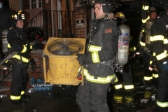 New York City. FDNY personnel extinguish a garage fire on East 29th Street and Kings Highway.
