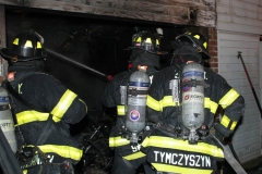 New York City. FDNY personnel extinguish a garage fire on East 29th Street and Kings Highway.
