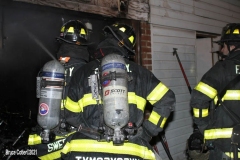 New York City. FDNY personnel extinguish a garage fire on East 29th Street and Kings Highway.