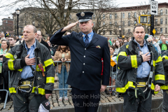 FDNY members salute during the National Anthem before the St. Patrick's Day Parade in the Park Slope neighborhood of Brooklyn, NY, on Mar. 20, 2022. (Photo by Gabriele Holtermann)