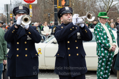 NYPD trumpet players play Taps before  the St. Patrick's Day Parade in the Park Slope neighborhood of Brooklyn, NY, on Mar. 20, 2022. (Photo by Gabriele Holtermann)