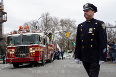An NYPD officer and the FDNY march in the St. Patrick's Day Parade in the Park Slope neighborhood of Brooklyn, NY, on Mar. 20, 2022. (Photo by Gabriele Holtermann)