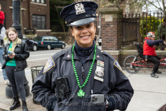An NYPD officer enjoys  the St. Patrick's Day Parade in the Park Slope neighborhood of Brooklyn, NY, on Mar. 20, 2022. (Photo by Gabriele Holtermann)