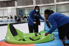 Staff members are wiping down the bumper cars after each ride at Bryant Park, New York on 27 Jan 2022.