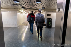 Riders exit the elevators and walk  down the terrazzo passageway toward the stairs leading to the platform.  Clark Street is one of the deepest stations in the entire system. This project did not make the statio ADA accessible.