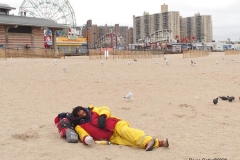 Coney Isalnd Boardwalk and the Coney Island Polar Bear Club which is the oldest winter bathing club in the United States founded in 1903. They swim every Sunday November-April at 1 PM.  Homeless man sleeping on the sand