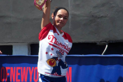 July 4  2022  NEW YORK  
Nathan's Famous Fourth of July International Hot Dog Eating Contest held at the corner of Surf ave. and Stillwell ave. where the original Nathan's Hot Dog stand opened over a hundred years ago.  Joey Chestnut win for the 15 year. eating 63 hot Dogs and Buns. Miki Sudo won eating 40 hot dogs and Buns. 
Michelle Lesco