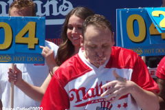July 4  2022  NEW YORK  
Nathan's Famous Fourth of July International Hot Dog Eating Contest held at the corner of Surf ave. and Stillwell ave. where the original Nathan's Hot Dog stand opened over a hundred years ago.  Joey Chestnut win for the 15 year. eating 63 hot Dogs and Buns.