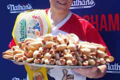 July 4  2022  NEW YORK  
Nathan's Famous Fourth of July International Hot Dog Eating Contest held at the corner of Surf ave. and Stillwell ave. where the original Nathan's Hot Dog stand opened over a hundred years ago.  Joey Chestnut win for the 15 year. eating 63 hot Dogs and Buns.