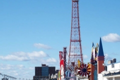 Coney Island Brooklyn. People stroll the Boardwalk in winter clothes on this sunny and cold day, 37 degrees some people sat on benches and others sunned themselves while The Coney Island Polar Bear Club jumped into the Atlantic Ocean for their weekly swim.