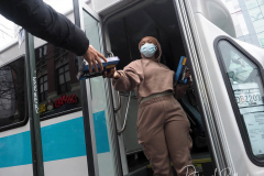 Workers distribute free Binax #COVID19 testing kits on West 125th Street in Harlem, New York City on 24 Dec 2021. The line was over 2 Avenues long