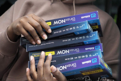 Workers distribute free Binax #COVID19 testing kits on West 125th Street in Harlem, New York City on 24 Dec 2021. The line was over 2 Avenues long