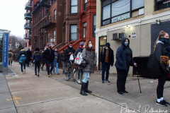 People waiting in line to receive the free Binax #COVID19 testing kits on West 125th Street in Harlem, New York City on 24 Dec 2021. The line was over 2 Avenues long.