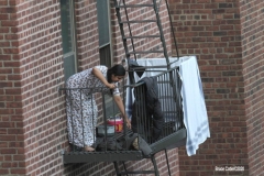 Woman picks up laundry that she put out earlier in the day.   8/9/2020