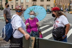 Members of the  Guardian Angels talk to a woman from the Upper West Side about the hotels turned homeless shelters in New York City on August 9, 2020. Residents have complained about an uptick in crime and drugs as well as the housing of sexual offenders in the neighborhood. (Photo by Gabriele Holtermann)