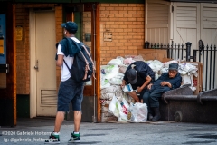 Two unsheltered New Yorkers sit outside the 72nd Subway Station on the Upper West Side in New York City on August 9, 2020. (Photo by Gabriele Holtermann)