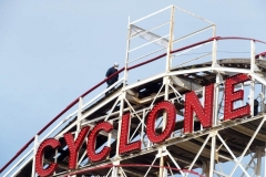 New York- Workers walk the tracks of the World Famous Coney Island Cyclone roller coaster in preparations for opening season. Last summer Coney Island was shut down because of the Covid Pandemic