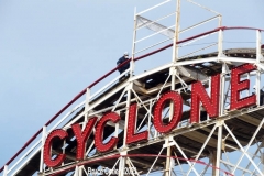 New York- Workers walk the tracks of the World Famous Coney Island Cyclone roller coaster in preparations for opening season. Last summer Coney Island was shut down because of the Covid Pandemic