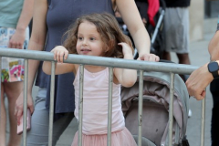 A young dance enthusiast watches the 16th annual New York Dance Parade in Manhattan NY on May 21, 2022. The annual parade made its return after being cancelled due to the COVID-19 pandemic with the theme of "Back to the Streets." (Photo by Andrew Schwartz)