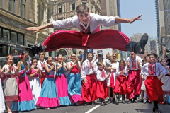 A member of the Ukrainian dance group Folk Dance Club Kaleidoscope leaps into the air during the 16th annual New York Dance Parade in Manhattan NY on May 21, 2022. The annual parade made it return after being cancelled due to the COVID-19 pandemic with the theme of "Back to the Streets." (Photo by Andrew Schwartz)