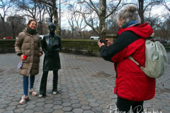 Photography fans pose with the bronze statue honoring the late photographer Diane Arbus by British conceptual artist Gillian Wearing in Doris C. Freedman Plaza in Central Park in New York City until August 14, 2022. The statue is presented by Public Art Fund