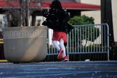 A child throws rose pedals on the ground outside the Christian Cultural Center during DMX's funeral on Sunday, April 25th.
