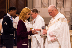 Cardinal Timothy Dolan gives communion to a High School senior at mass with nearly  2,000 graduating Catholic High School seniors at St. Patrick’s Cathedral in New York, New York, on May 18, 2022. (Photo by Gabriele Holtermann/Sipa USA)