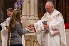 Cardinal Timothy Dolan gives communion to a High School senior at mass with nearly  2,000 graduating Catholic High School seniors at St. Patrick’s Cathedral in New York, New York, on May 18, 2022. (Photo by Gabriele Holtermann/Sipa USA)