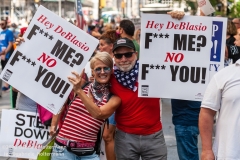 A couple holding signs expressing their dissatisfaction with Mayor de Blasio, attends the "Don't Give Up the Ship" rally outside City Hall Park in New York City on August 22, 2020. The rally, led by Staten Island based artist Scott LoBaido, called out the Mayor's failure addressing the recent spike in gun violence and increase in homeless encampments. (Photo by Gabriele Holtermann)
