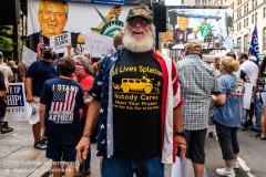 A man wearing a shirt "All Lives Splatter" attends  the "Don't Give Up the Ship" rally outside City Hall Park in New York City on August 22, 2020. The rally, led by Staten Island based artist Scott LoBaido, called out the Mayor's failure addressing the recent spike in gun violence and increase in homeless encampments. (Photo by Gabriele Holtermann)