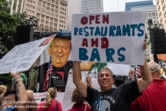 A rally attendant holds a sign demanding to open bars and restaurants at  the "Don't Give Up the Ship" rally outside City Hall Park in New York City on August 22, 2020. The rally, led by Staten Island based artist Scott LoBaido, called out the Mayor's failure addressing the recent spike in gun violence and increase in homeless encampments. (Photo by Gabriele Holtermann)