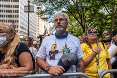 A man listens to the American National Anthem at the "Don't Give Up the Ship" rally outside City Hall Park in New York City on August 22, 2020. The rally, led by Staten Island based artist Scott LoBaido, called out the Mayor's failure addressing the recent spike in gun violence and increase in homeless encampments. (Photo by Gabriele Holtermann)