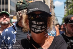 A woman wears a mask thinking its as useless as NY Governor Cuomo  the "Don't Give Up the Ship" rally outside City Hall Park in New York City on August 22, 2020. The rally, led by Staten Island based artist Scott LoBaido, called out the Mayor's failure addressing the recent spike in gun violence and increase in homeless encampments. (Photo by Gabriele Holtermann)