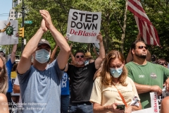 A man holds up a sign demanding de Blasio to step down at  the "Don't Give Up the Ship" rally outside City Hall Park in New York City on August 22, 2020. The rally, led by Staten Island based artist Scott LoBaido, called out the Mayor's failure addressing the recent spike in gun violence and increase in homeless encampments. (Photo by Gabriele Holtermann)