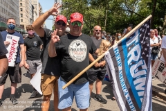 Two Proud Boys, flashing the Proud Boys symbol and holding a Trump flag, attend  the "Don't Give Up the Ship" rally outside City Hall Park in New York City on August 22, 2020. The rally, led by Staten Island based artist Scott LoBaido, called out the Mayor's failure addressing the recent spike in gun violence and increase in homeless encampments. (Photo by Gabriele Holtermann)