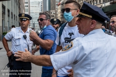 NYPD officers diffuse a tense situation between Black Lives Matter protestors and Blue Lives Matter protestors after  the "Don't Give Up the Ship" rally outside City Hall Park in New York City on August 22, 2020. The rally, led by Staten Island based artist Scott LoBaido, called out the Mayor's failure addressing the recent spike in gun violence and increase in homeless encampments. (Photo by Gabriele Holtermann)