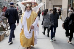 Participants march in the 2021 Annual Easter Bonnet Parade on Fifth Avenue in New York City on April 4, 2021. Paradegoers either dressed in their finest clothing or in colorful bonnets of all shapes and sizes still attended the annual Easter holiday tradition, on the steps of St. Patrick's Cathedral or in nearby Rockefeller Center, despite the Covid 19 pandemic. A man dressed as Jesus walks along Fifth Avenue. (Photo by Andrew Schwartz)