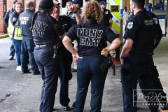 EMT Shot
West Brighton, Staten Island, NY
Photograph by Mary DiBiase Blaich

EMT Richard McMahon was released from Richmond University Medical Center on Thursday, May 19, 2022 after a harrowing incident the evening before.
On Wednesday, May 18, 2022, an EMT crew from Richmond University Medical Center responded around 7:30 PM to a call of an EDP at “The Funkey Monkey Lounge”, located at 1205 Forest Avenue.  They removed the individual and began a transport to Richmond University Medical Center (RUMC).  A mile into their transport, the patient, Thomas McCauley, 37 yrs old, pulled a gun on the EMT, Richard McMahon, and  shot him.  The ambulance driver pulled over on the 600 block of Forest Avenue, at Bement Avenue.  The patient then bolted out of the ambulance, attempting to escape.  He was captured at the location by two passers by,  a retired NYPD Detective, Marty Grahm and a DSNY Lt Joseph Perrone, who was off duty with his family.  
Both Grahm and Perrone came to RUMC as EMT McMahon was released to cheering EMT’s from all over the region.