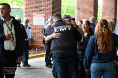 EMT Shot
West Brighton, Staten Island, NY
Photograph by Mary DiBiase Blaich

EMT Richard McMahon was released from Richmond University Medical Center on Thursday, May 19, 2022 after a harrowing incident the evening before.
On Wednesday, May 18, 2022, an EMT crew from Richmond University Medical Center responded around 7:30 PM to a call of an EDP at “The Funkey Monkey Lounge”, located at 1205 Forest Avenue.  They removed the individual and began a transport to Richmond University Medical Center (RUMC).  A mile into their transport, the patient, Thomas McCauley, 37 yrs old, pulled a gun on the EMT, Richard McMahon, and  shot him.  The ambulance driver pulled over on the 600 block of Forest Avenue, at Bement Avenue.  The patient then bolted out of the ambulance, attempting to escape.  He was captured at the location by two passers by,  a retired NYPD Detective, Marty Grahm and a DSNY Lt Joseph Perrone, who was off duty with his family.  
Both Grahm and Perrone came to RUMC as EMT McMahon was released to cheering EMT’s from all over the region.