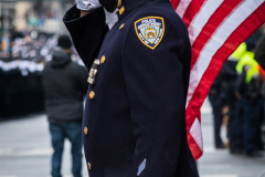 An NYPD officer stands in salute of his fallen colleague, NYPD Officer Wilbert Mora after his funeral service at St. Patrick’s Cathedral in New York, New York, on Feb. 2,  2022.  (Photo by Gabriele Holtermann/Sipa USA)